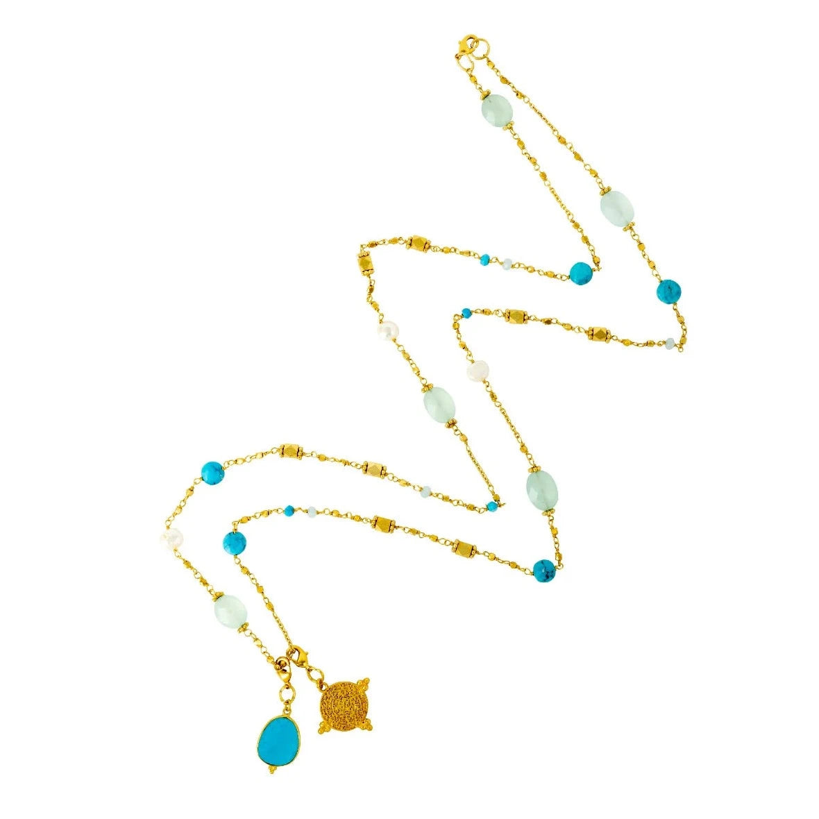 This necklace, from Mazzi D Fiori, features a variety of gemstones, including turquoise, chalcedony, agate, and freshwater pearl, strung together in a multiway design. It also includes two detachable charms - a signature gold coin and a turquoise gemstone. The necklace can be worn long or doubled up, and the charms can be rearranged to fit your desired style. It is a beautiful and versatile piece to add to any jewelry collection.