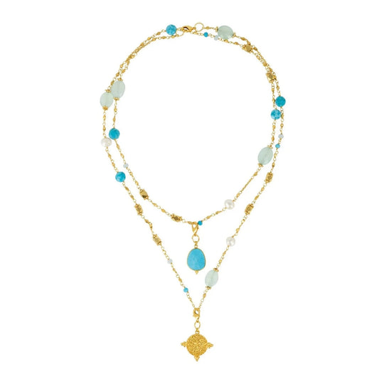 This necklace, from Mazzi D Fiori, features a variety of gemstones, including turquoise, chalcedony, agate, and freshwater pearl, strung together in a multiway design. It also includes two detachable charms - a signature gold coin and a turquoise gemstone. The necklace can be worn long or doubled up, and the charms can be rearranged to fit your desired style. It is a beautiful and versatile piece to add to any jewelry collection.