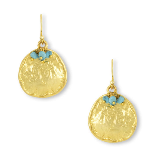 These handmade, drop earrings from Mazzi D Fiori, feature a rustic textured coin design and are adorned with turquoise gemstone beads and faceted semi-precious mini beads. Made with gold-plated materials, they are lightweight and versatile, perfect for both everyday use and more formal events. This style is a timeless addition to any accessory collection.